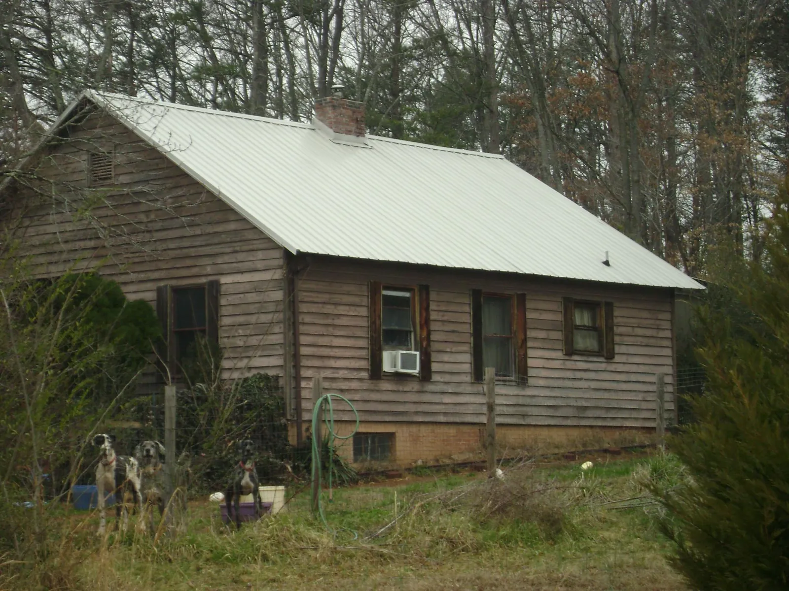 White metal roof on an old wood sided farmhouse, from a Metal Roof Installation job in Canaan